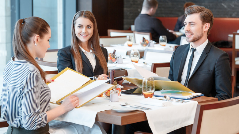 Friends dining in formal clothing