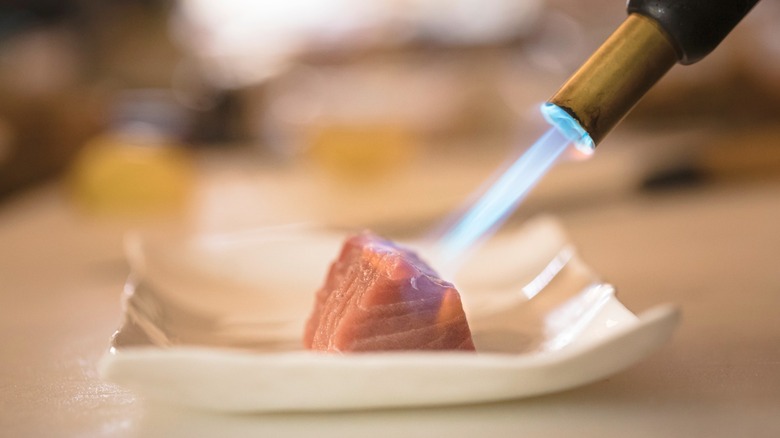 Using a kitchen torch to cook tuna