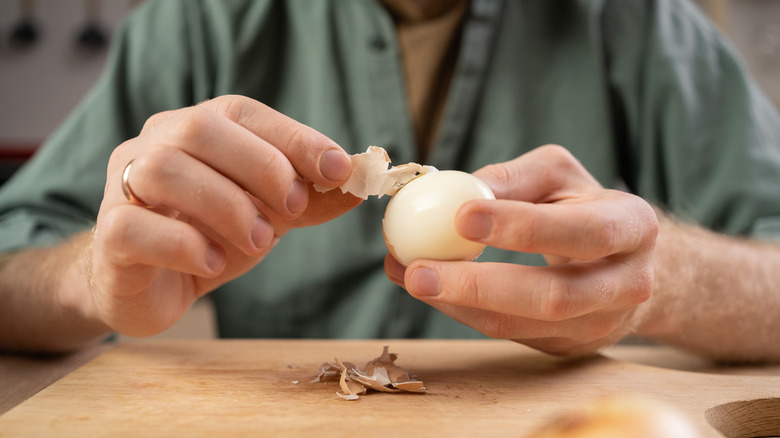 Man peeling a hard-boiled egg