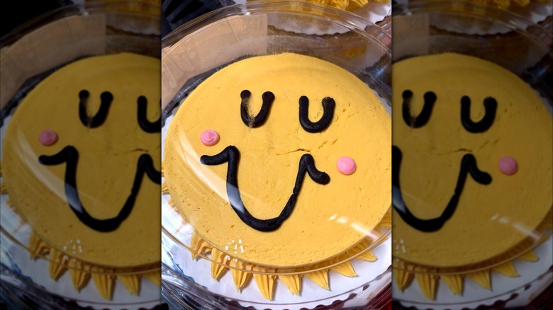 A sunshine yellow cake with a smiley face from Walmart