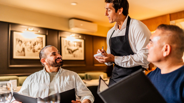 Waiter taking an order from restaurant customers
