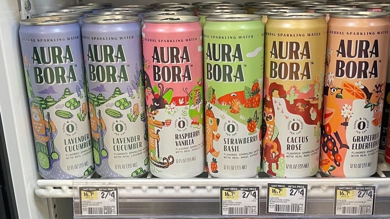 Cans of Aura Bora in a retail store cooler