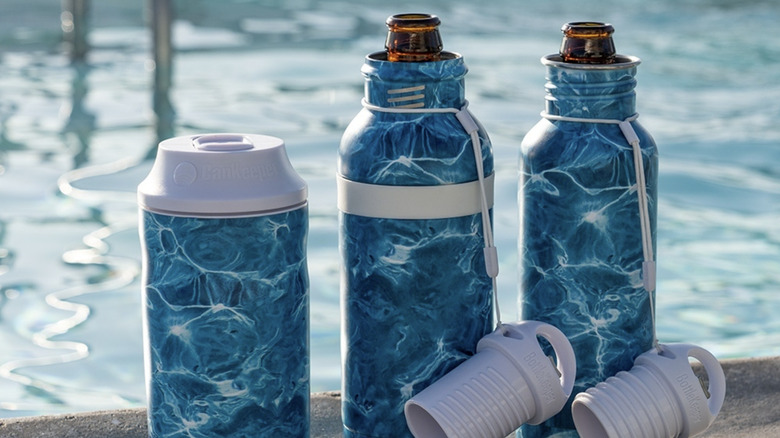 BottleKeeper products with stylish blue patterns placed beside a pool.