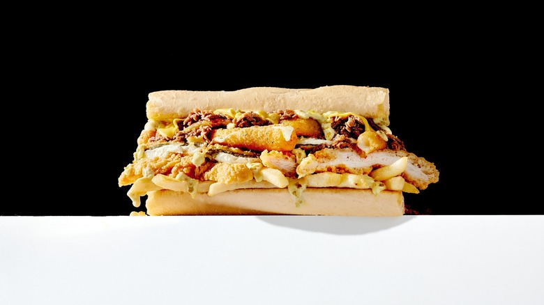 A Fat Shack burger against a black ground