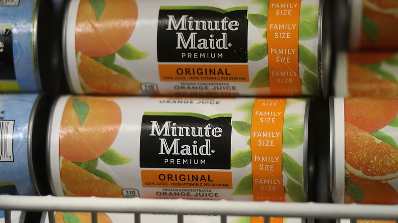Stacked cans of Minute Maid orange juice concentrate