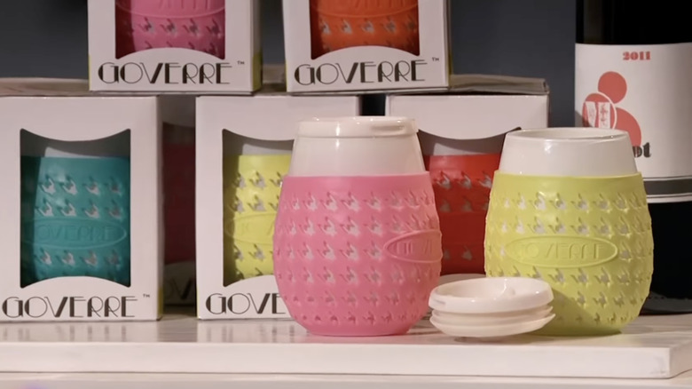 Goverre glasses in different colors displayed on a white table.