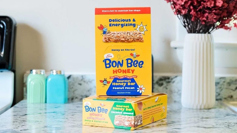Two boxes of Bon Bee Honey bars stacked on a counter with an instagram caption about the product