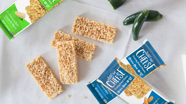Just The Cheese products displayed on top of a white cloth.