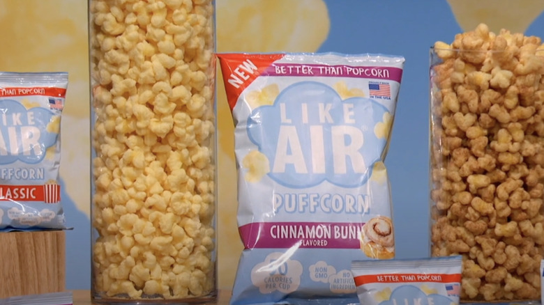 A display of the Like Air Puffcorn snacks, both packed and in tall glasses.