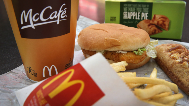 A large meal, including a chicken sandwich, coffee, an apple pie and french fries from McDonald's