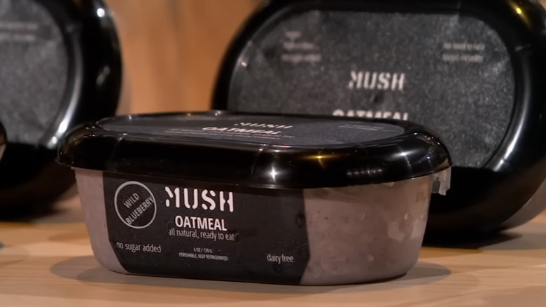 MUSH oatmeal products displayed on a wooden table.