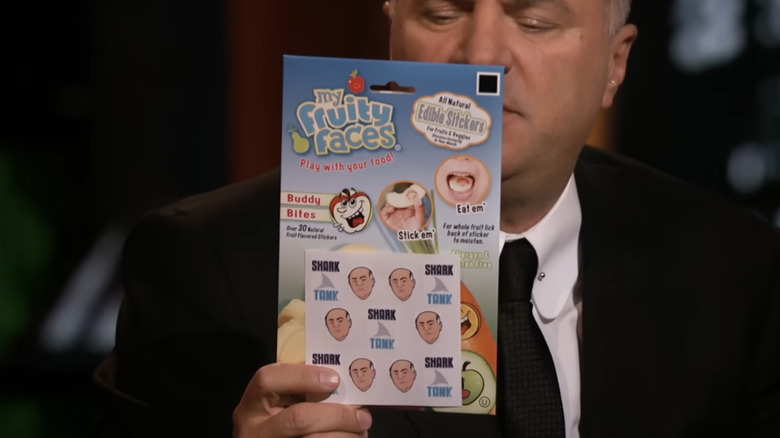 Kevin O'Leary looking at a bundle of the My Fruity Faces edible stickers, featuring a mini caricature of him