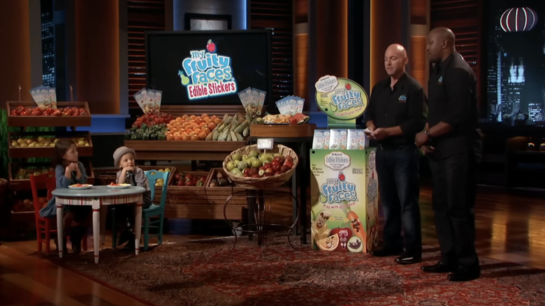 My Fruity Faces co-founders Adam Gerber and Bob Ntoya presenting their product to the Sharks, with the help of two kids.