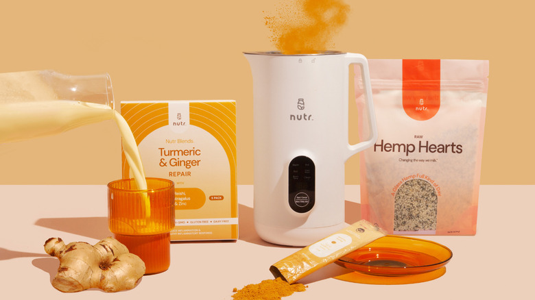 The Nutr machine surrounded by various packets to use to create drinks