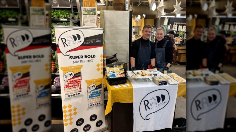Emily and Cole Williams posing behind a food stall for Radd Foods