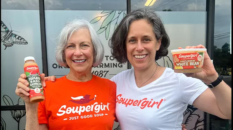 Marilyn and Sara Polon smile to the camera while proudly holding samples of their company's products.