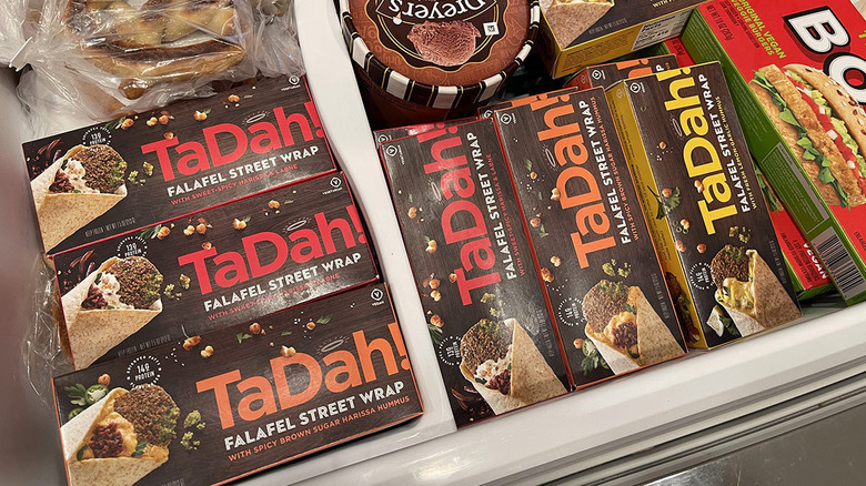 Boxes of TaDah falafel wraps in a deep freezer at a grocery store.