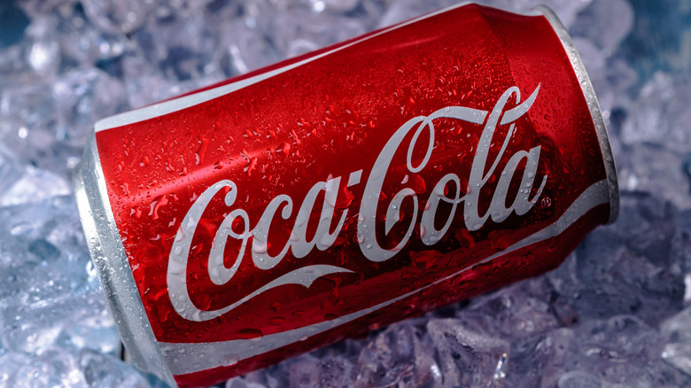 A can of Coca-Cola on a bed of ice cubes