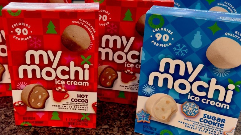 Boxes of My/Mochi on counter showing different holiday flavors