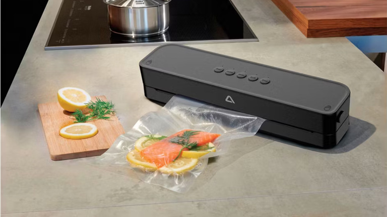 Black Ambiano vacuum sealer vacuum sealing salmon with lemon and dill