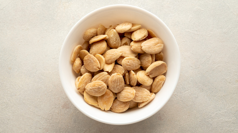 Small white bowl of marcona almonds
