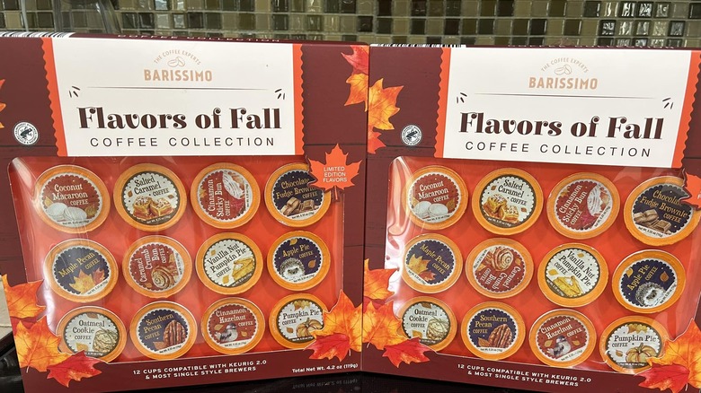Two Aldi autumn-flavored K-cups standing upright in front of green tiles