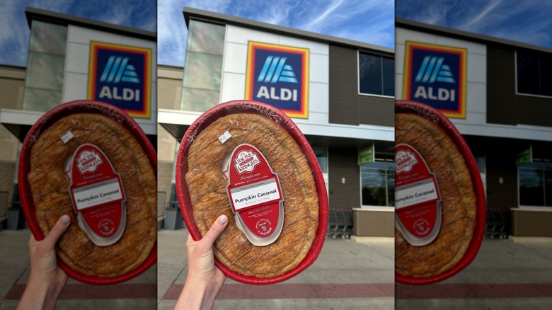 hand holding a pumpkin caramel kringle outside an Aldi store