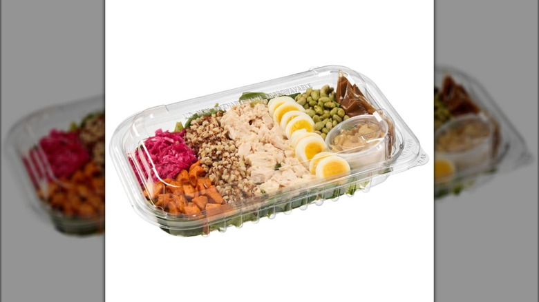 The protein-heavy Kirkland Signature Chicken & Grain Bowl with Asian Dressing from Costco on a white background.