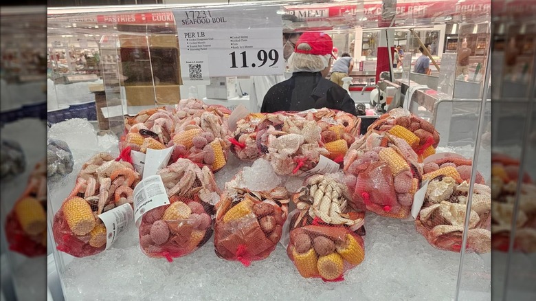 Several bags of the Kirkland Signature Seafood Boil Kit on ice at Costco