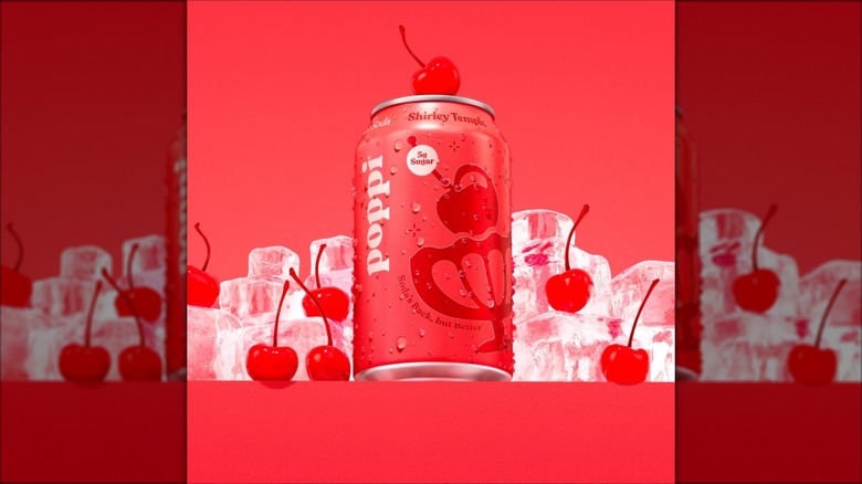 A can of Poppi Shirley Temple Soda on a cherry red background with cherries and ice cubes around it.