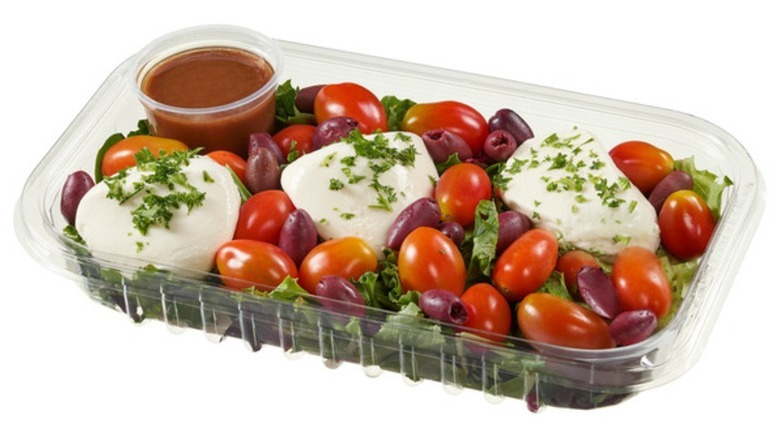 Kirkland Signature Burrata Salad in a clear plastic tray on a white background.