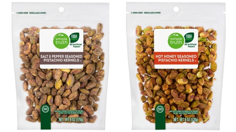 Simple Truth Salt and Pepper Pistachio Kernels and Simple Truth Hot Honey Seasoned Pistachio Kernels in clear plastic bags on a white background.