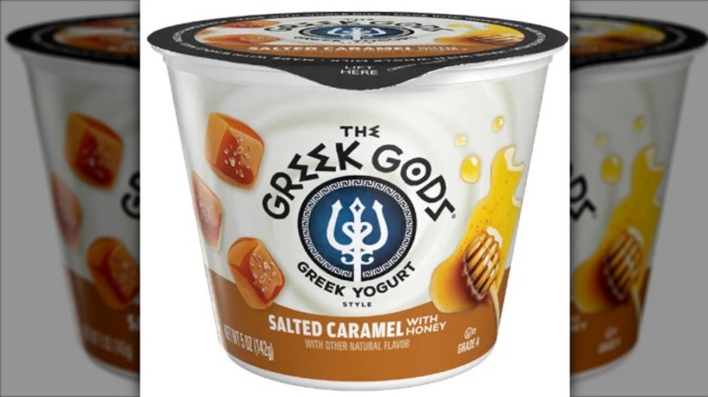 A cup of The Greek Gods salted caramel honey yogurt on a white background.