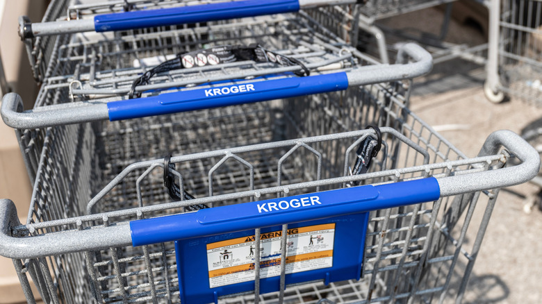 shopping cart and cell phone showing Kroger app