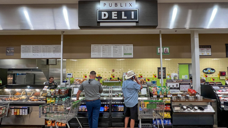 Shoppers wait at the Publix deli counter