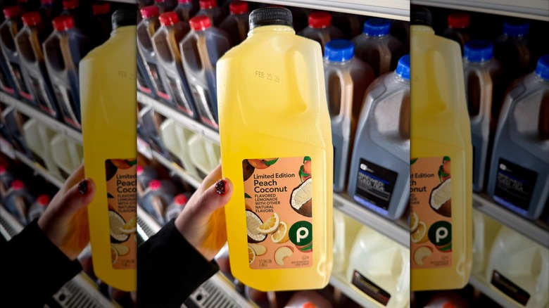 Person holding jug of peach coconut lemonade