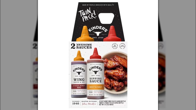 Two bottles of Kinder's Sticky Honey and Sweet & Tangy Wing & Dipping Sauces in package on white background