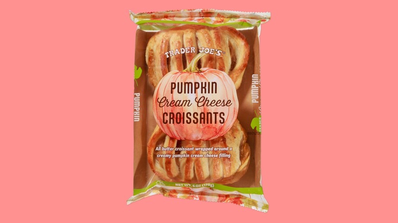 A 2-pack bag of Pumpkin Cream Cheese Croissants from Trader Joe's on a pink background.