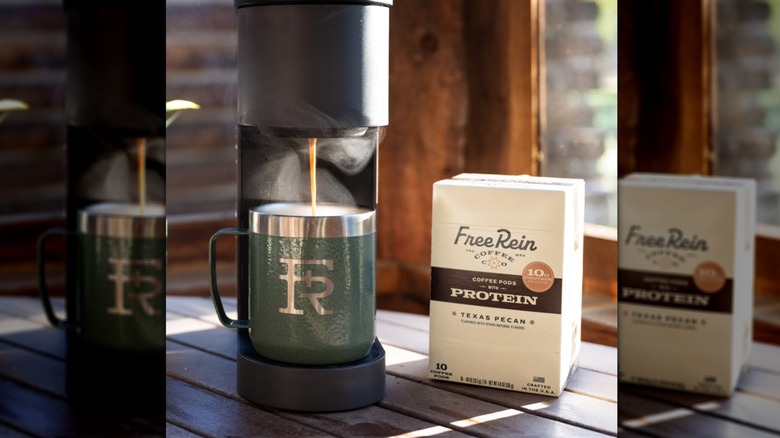 A Keurig machine brewing Free Rein protein coffee in a farmhouse setting.