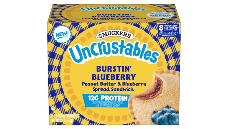 A box of Smucker's Uncrustables Burstin' Blueberry Protein Snacks on a white background.
