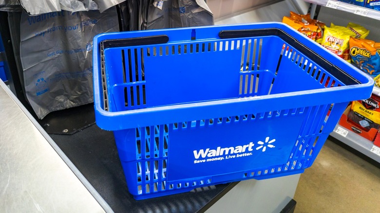 Walmart self‑checkout area with hand basket featuring a Walmart logo