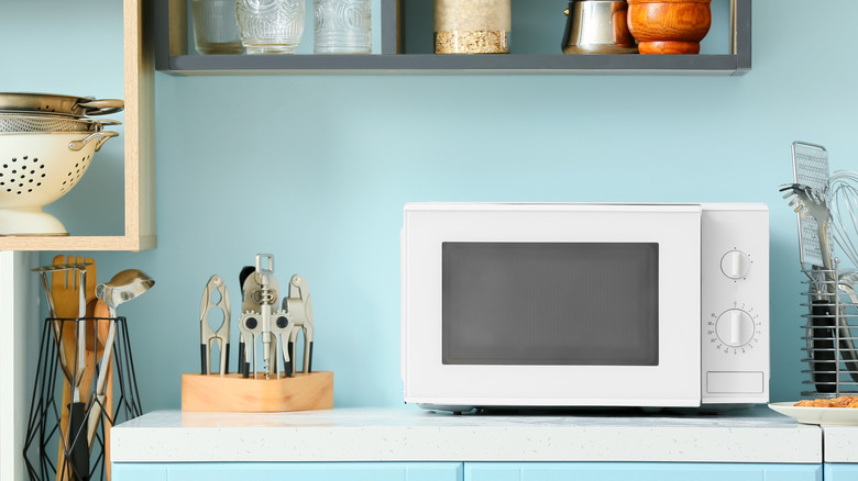 A white microwave on a kitchen counter