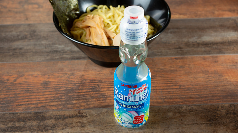 A bottle of ramune sitting on a table.