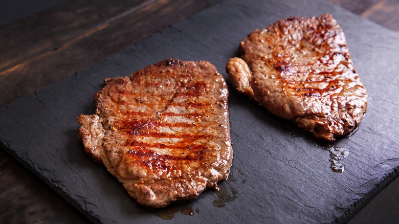 Grilled cubed steak on top of marble slab