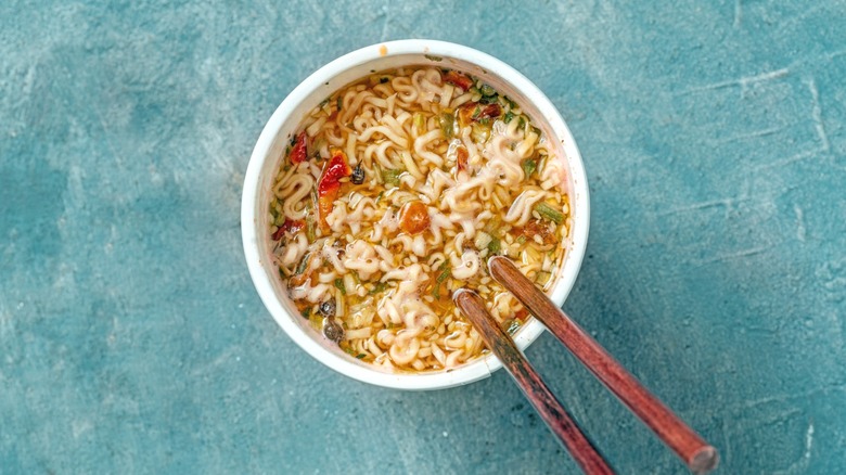 A cup of instant noodles, viewed from above.