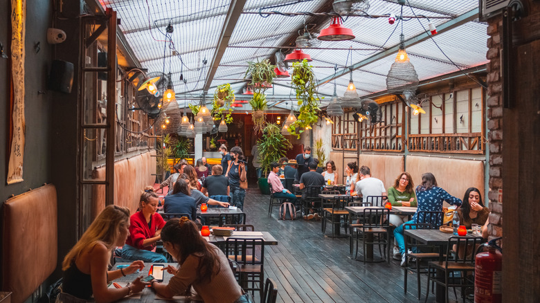 Restaurant interior with guests at many tables