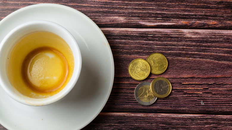 Coffee cup with euro coins on table