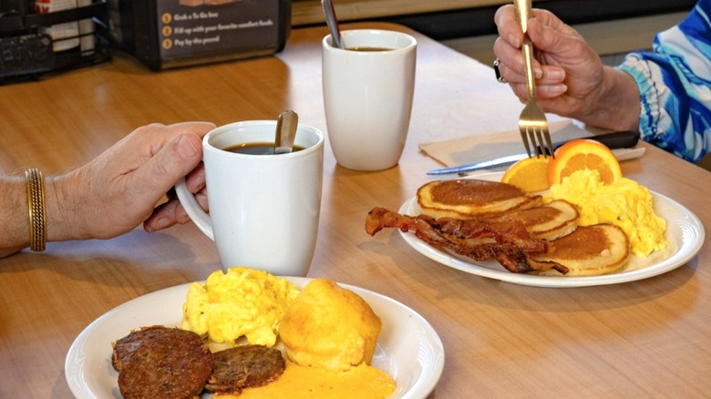 Two people eating breakfast at Golden Corral restaurant