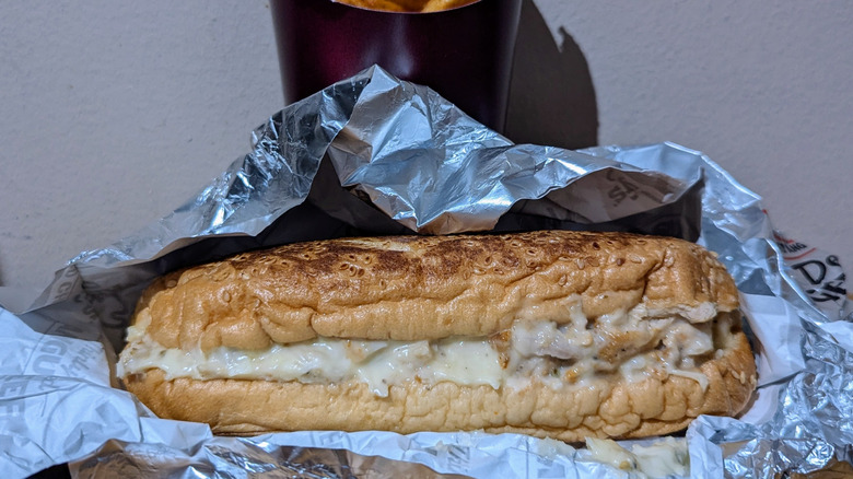 Arby's chicken cheesesteak resting on foil.