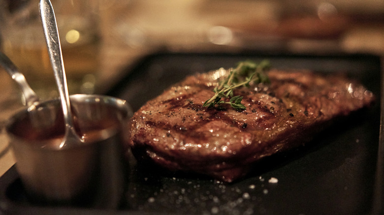 cooked steak with sear marks and microgreens on top
